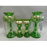 A pair of green glass table lustres and matching vases