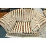 A Knowle style two seater settee upholstered in cream and pink brocade fabric