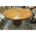 An early Victorian mahogany circular tilt top breakfast table on faceted column,