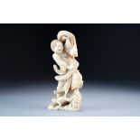 A Japanese ivory okimono of Gama Sennin, Meiji period, modelled standing on a rocky base,