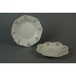 Two Staffordshire salt-glaze plates with moulded centres and pierced borders, circa 1760, 21.