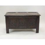 A joined oak chest 17th century the rectangular bevelled three panel top above a guilloche carved