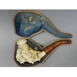 A cased large carved meerschaum pipe with bird and wolf decoration