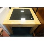 A beech frame coffee table with polished black stone inset top on square legs,