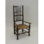 An ash wood rush seat low open armchair,