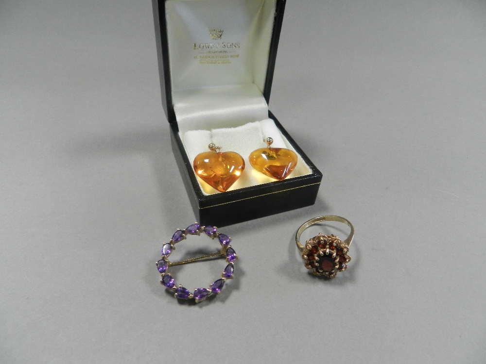 An amethyst set wreath brooch stamped 375 together with a 9ct gold garnet cluster ring and a pair