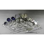 A collection of silver mounted button hooks together with silver napkin rings, a silver bangle,