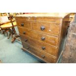 A Victorian scumbled pine oak effect chest of two short and three long graduated cockbeaded drawers