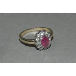 A 9ct gold ruby and diamond oval cluster ring