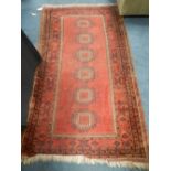 A Persian red ground rug,