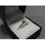 An 18ct white gold single stone diamond ring with crossover shank