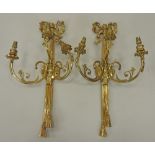 A pair of Louis XVI style gilt metal three branch wall lights, each of ribbon,