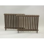 A pair of cast iron freestanding radiators,