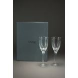 A pair of Lalique crystal wine glasses decorated with white opalescent cherubs,