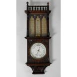 A Victorian oak aneroid barometer, the 7.