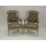 A pair of Louis XVI style open armchairs, circa 1900, each with panel back and overstuffed seat,