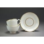 A Caughley trio of coffee cup, tea bowl and saucer in plain white,