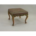 A carved giltwood framed foot stool mid 19th century,