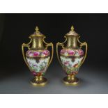 A pair of Copeland Spode twin-handled vases and covers painted with flowers and gilt by Thomas