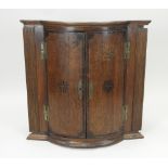 A George III crossbanded mahogany bow centre wall hanging corner cabinet,