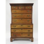 A George III oak chest on chest, the dentil moulded cornice over three short and six long drawers,