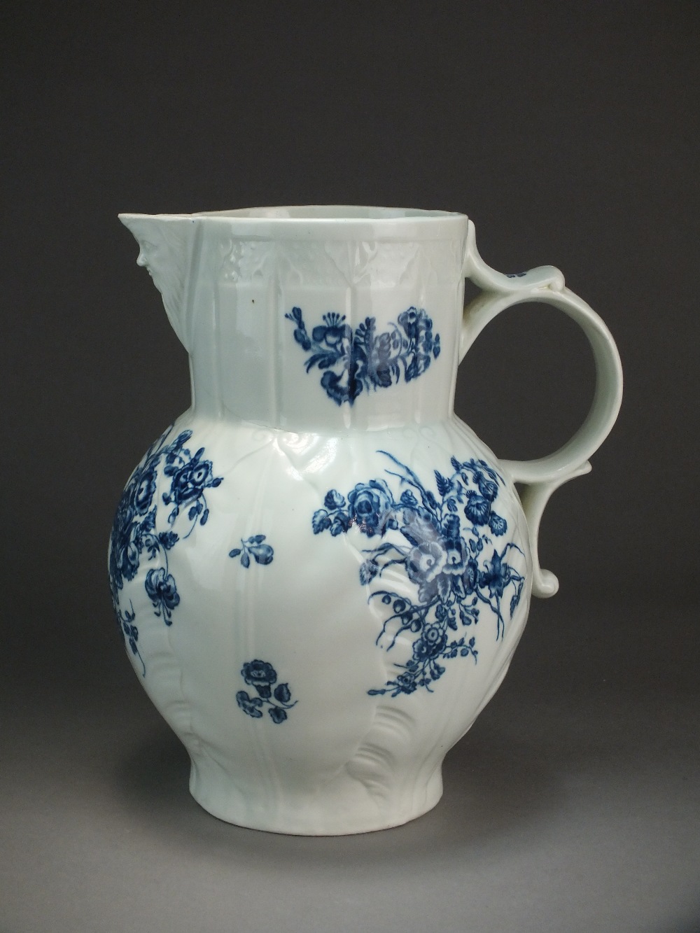 A Caughley mask head cabbage leaf jug transfer-printed in the Bouquets pattern, circa 1776-79,