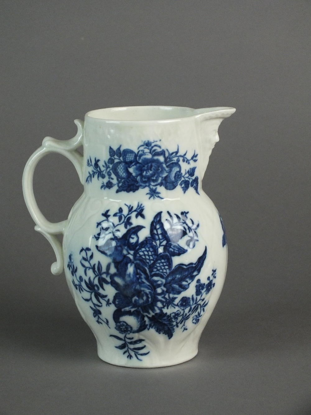 A Caughley mask head jug transfer-printed with the Pine Cone pattern, circa 1785-92, S mark, 14.