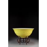 A rare Chinese lemon-yellow moulded bowl, Daoguang mark and probably period, of inverted bell form,