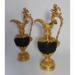 A pair of gilt metal and bronze patinated ewers in the Renaissance style in the manner of Francois