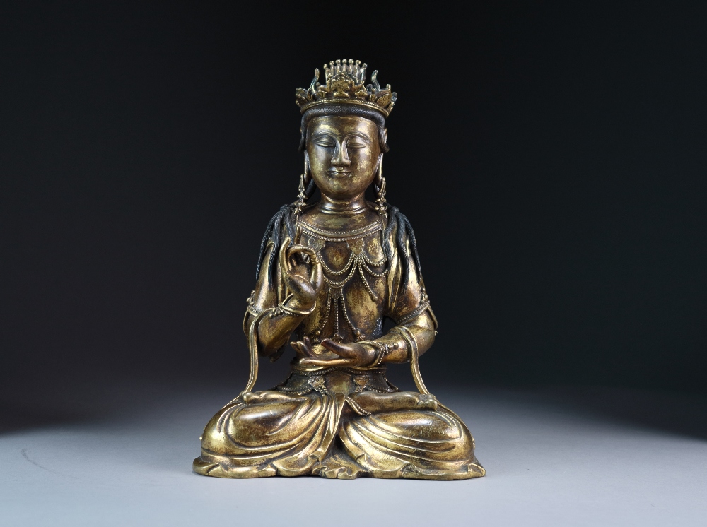 A Chinese gilt bronze figure of Guanyin, Qing Dynasty, modelled seated in dhyanasana,