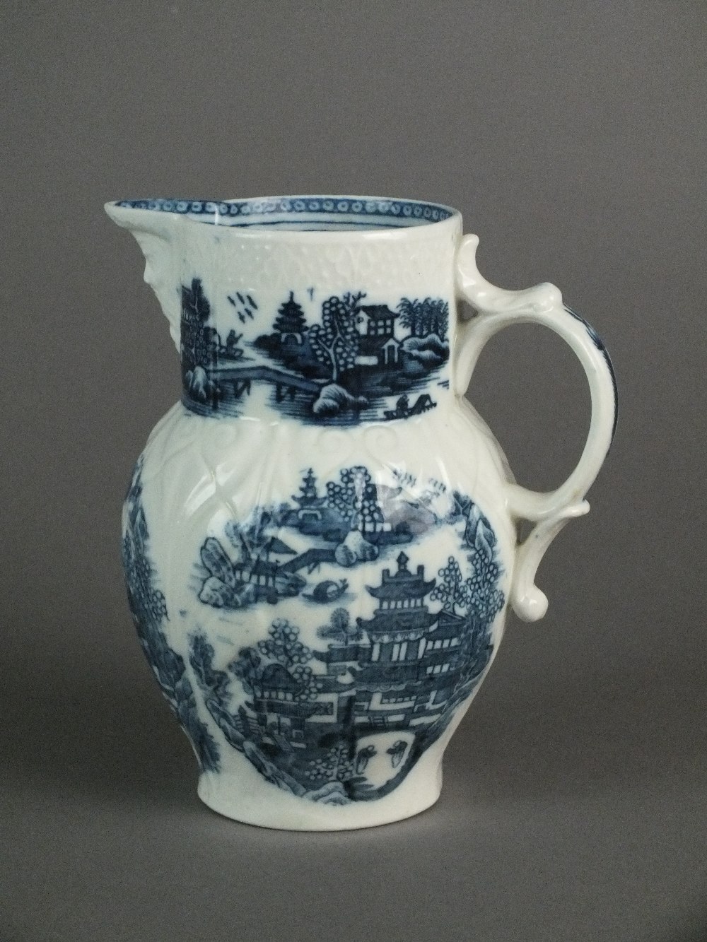 A Caughley mask head jug transfer-printed with the Conversation pattern, circa 1782-93, unmarked, - Image 2 of 2