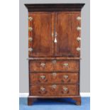 An early 18th century and later walnut feather banded cabinet on chest,