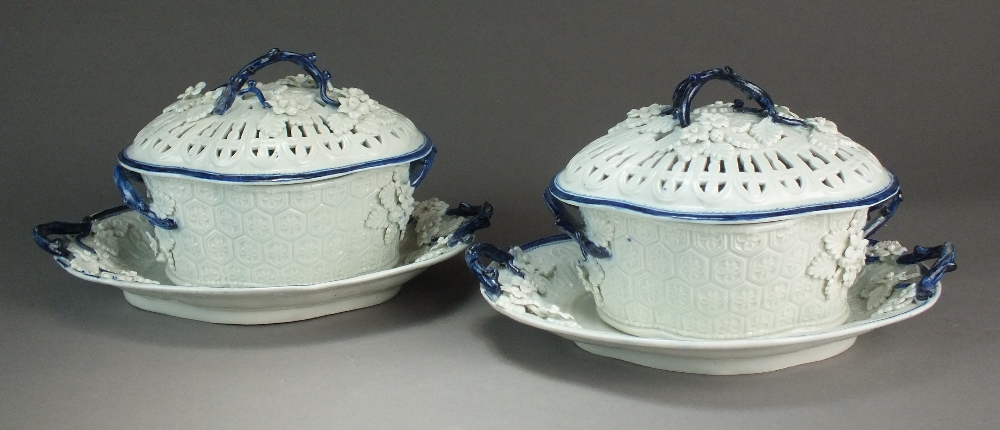 A pair of Caughley chestnut baskets, covers and stands painted with the Salopian Sprig pattern,