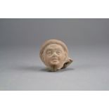 An Egyptian terracotta head of a child, Alexandria region, circa 1st-2nd Century AD,