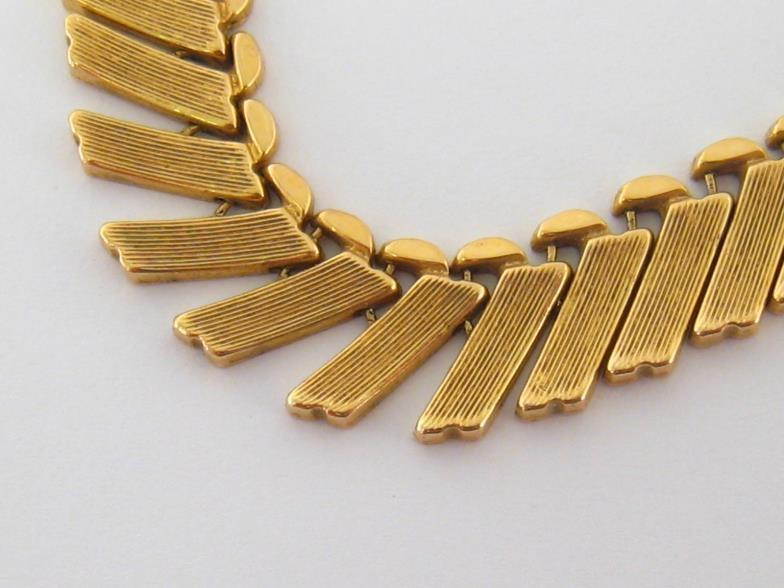 A yellow metal (tests 18 carat gold) fringe necklace, composed of obliquely set textured rectangular - Image 2 of 4