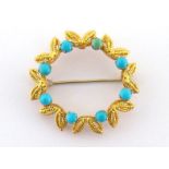 A turquoise circlet brooch, the wreath design set with small round cabochons, marked '750' verso,