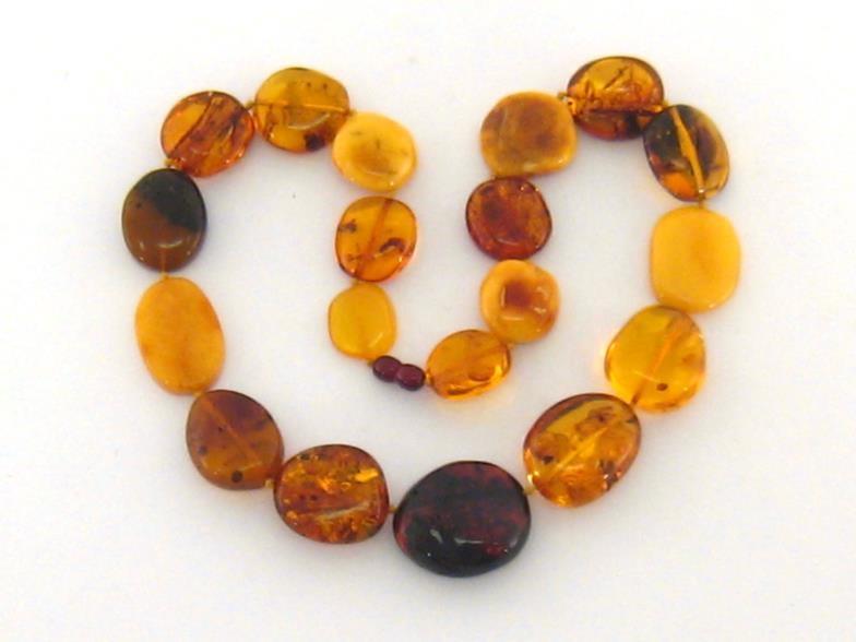 An amber necklace, composed of large polished flattened off round transparent and opaque beads, to a