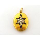 A Victorian diamond and enamel locket, the oval two piece hinged case set to the front with a star