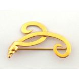 A yellow metal brooch, of scroll design, stamped '18ct' verso, 5.5cm long, 8.6gms