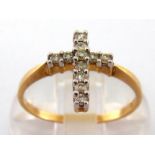 A diamond ring, the bezel forming a cross, pave set with brilliants overall, totalling 0.20 carat,