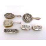 A group of six Chinese Export silver dressing table items comprising:- a hand mirror and matching