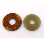 Two Chinese jade plain carved bi, one celadon, one brown, 20th century, Diam. 5.5cm and 6cm