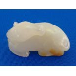 A Chinese white jade carving of a recumbent horse, in very white colour with tiny brown skin, 19th/