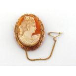 A late Victorian shell cameo brooch, the oval cameo depicting a woman in profile, 3.6cm long, in a