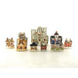 A collection of nine 19th. century and later Staffordshire flatback ceramic models, money boxes,