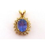 A tanzanite and diamond pendant, the central oval cut tanzanite approx. 1.65 carat, in a surround of