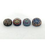 A collection of four millefiori paperweights with latticino divisions, one with central cane