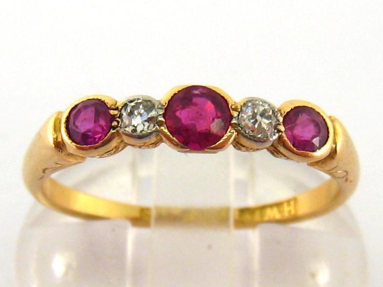 An early 20th century ruby and diamond five stone ring, composed of graduated alternate round cut