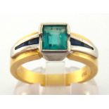 A gentleman's emerald and blue sapphire ring, the central rectangular cut emerald approx. 0.82