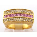 A French 18 carat gold, pink sapphire and diamond ring, composed of a central row of calibre cut
